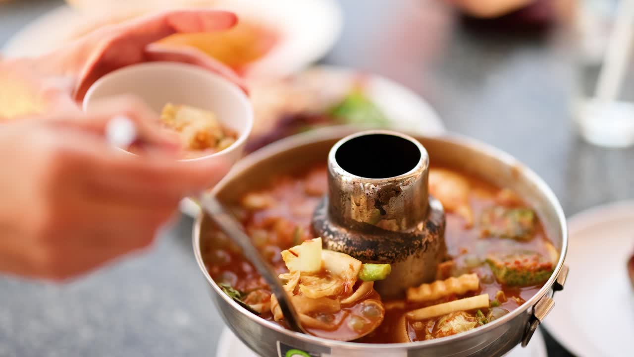 Enjoying a bowl of Tom Yum soup