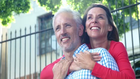 mature couple is relaxing and embracing in the street