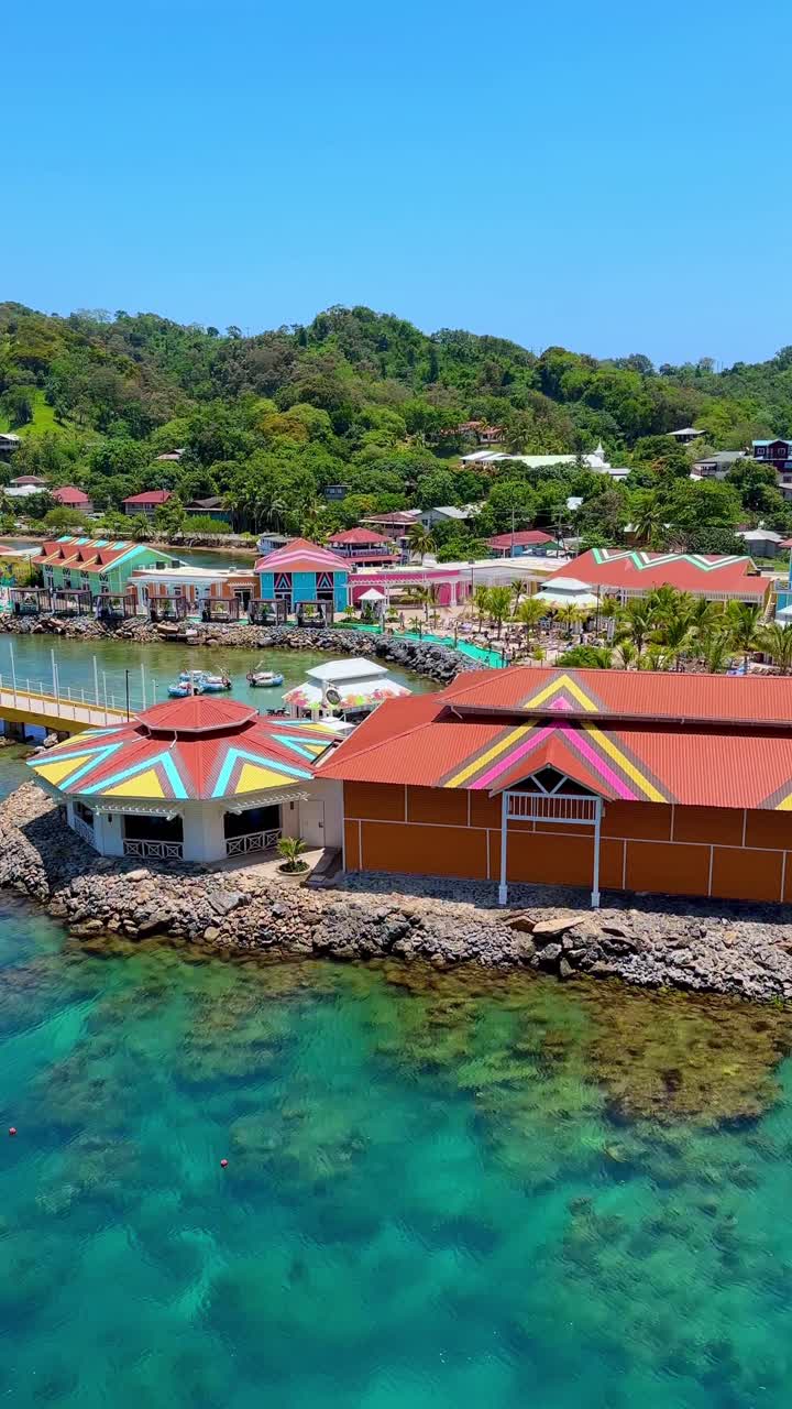 Colorful and scenic cruise port of call village on sunny day, Roatan Hunduras, vertical