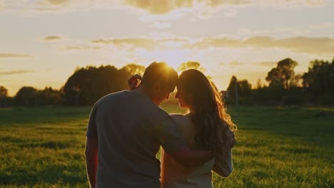 couple enjoying sunset in a field
