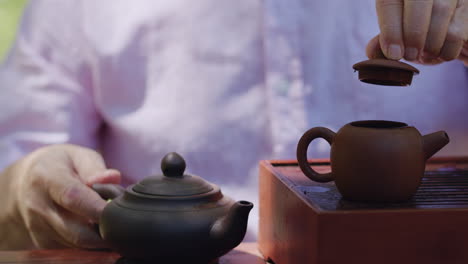 man pours water into teapot, steeps tea, relaxing, slow motion