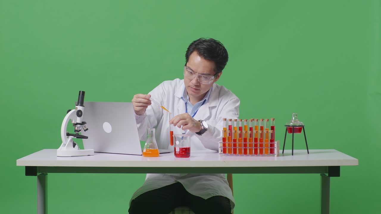 Asian Man Scientist Making Experiment With Test Tube And Typing On A Laptop Then Having A Headache On The Table With Microscope In The Green Screen Background Laboratory
