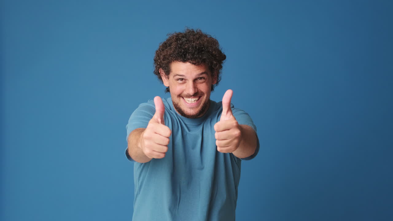 Happy Man Giving Thumbs Up Gesture on Blue Background