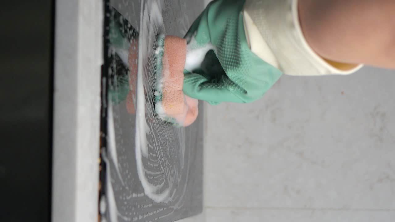 Cleaning a surface with a sponge and soap