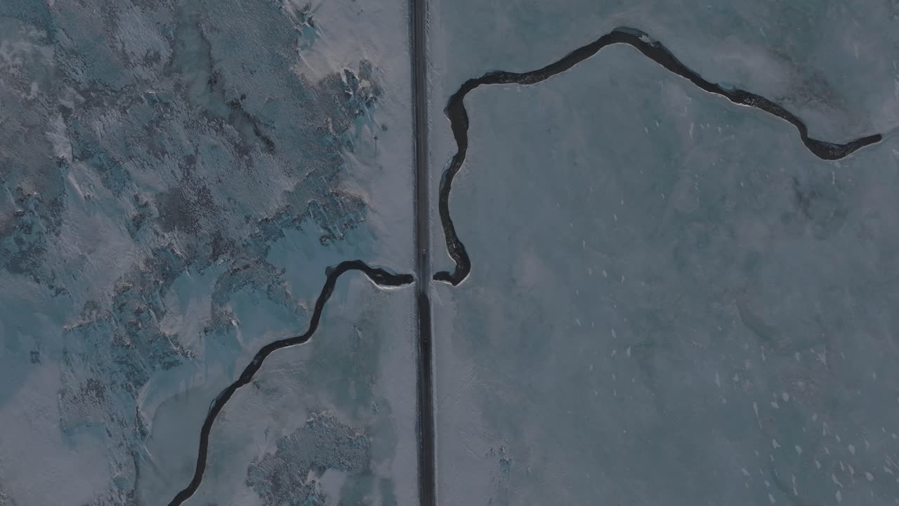 Highway Road over Frozen Ice River in Iceland - Aerial Drone Top View