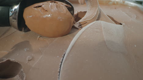 close-up slow motion shot of a spoon scooping a rich, creamy ball of chocolate ice cream. the luscious dark texture and smooth surface highlight the indulgent nature of this frozen dessert