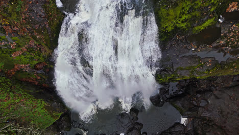 4k drone footage flying above waterfall in forest