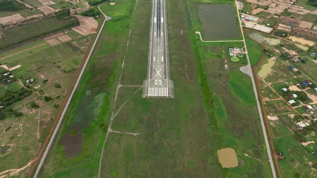 Aerial shot of an old unused airport runway in Siem Reap, Cambodia, with lush surroundings
