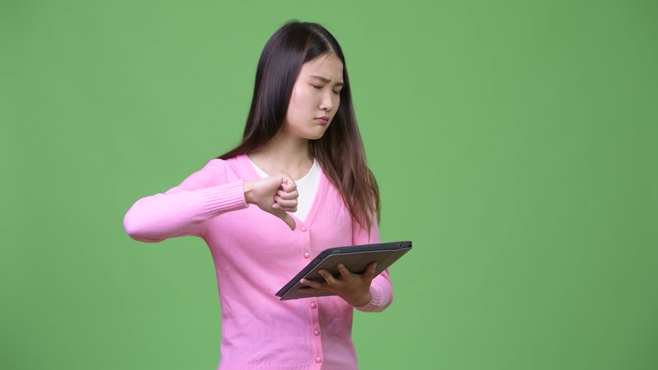 Young beautiful Asian woman using digital tablet
