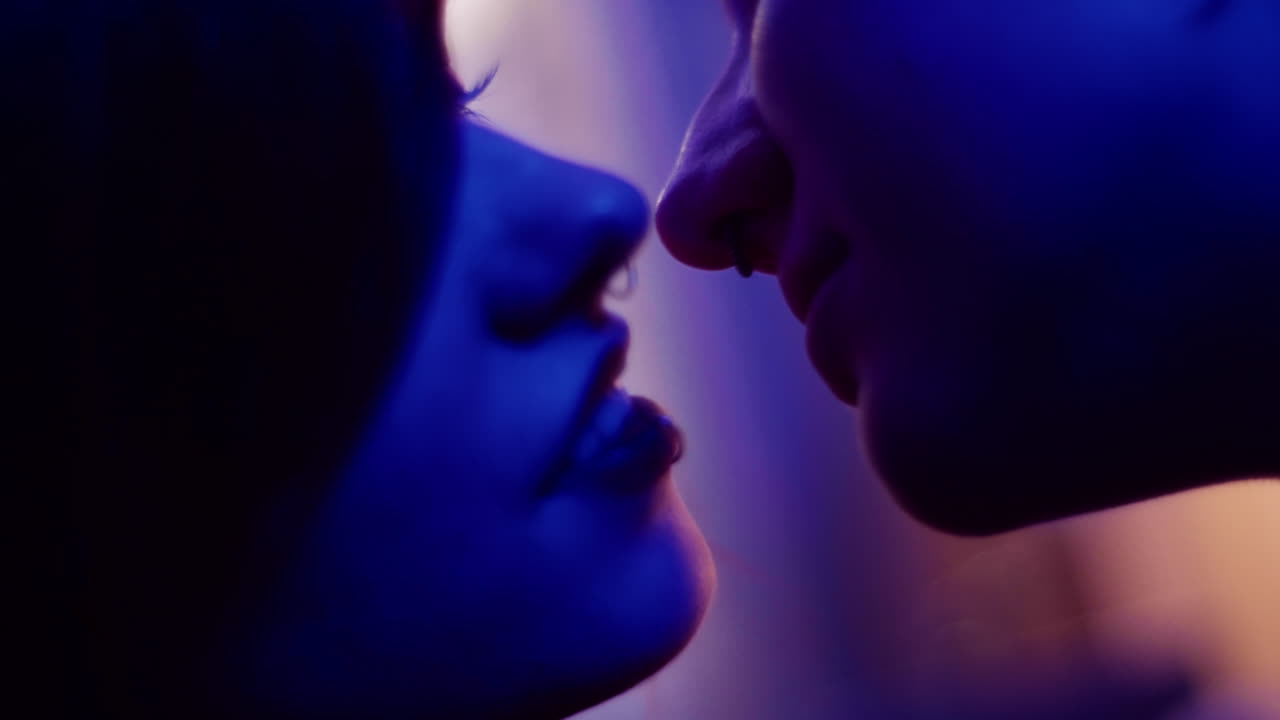 Couple Kissing Under Blue Light