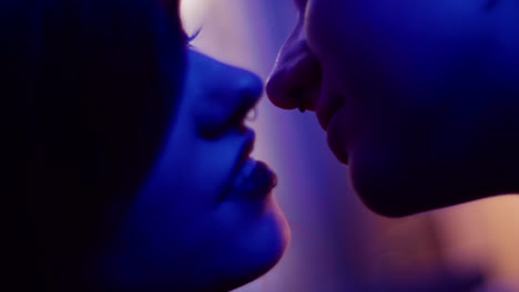 couple kissing under blue light