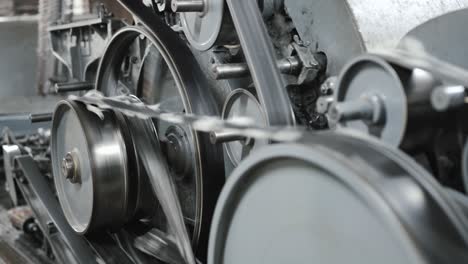 old vintage loom, many rotating wheels