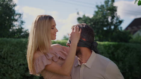 Smiling-man-in-blind-embracing-woman-on-backyard.-Husband-holding-wife-on-hands