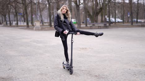 woman riding an electric scooter in a park