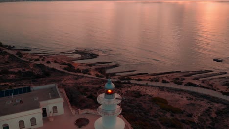 beautiful lighthouse on the mediterranean sea with mountains on background shot on sunrise on costa blanca spain