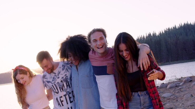 Friends Enjoying Sunset By The Lake