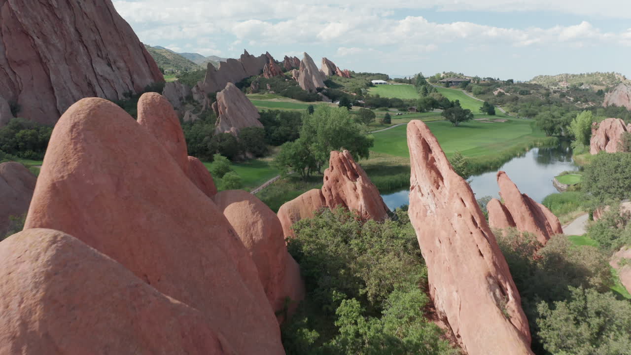 푸른 잔디, 붉은 바위, 푸른 하늘이 있는 리틀턴 콜로라도의 애로우헤드 골프 코스 리조트