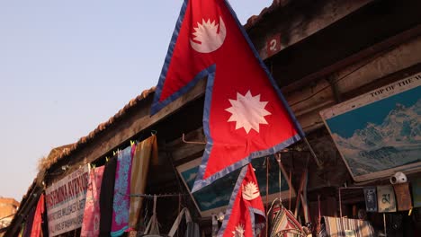 nepali flag in durbar square in kathmandu, nepal at the base of the himalayas