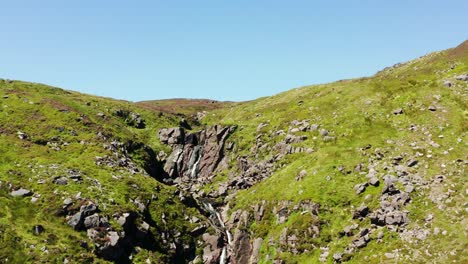 scenic aerial view of mahon falls with lush green terrain and visitors exploring