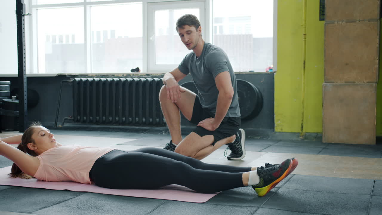 Woman Doing Crunches with Personal Trainer