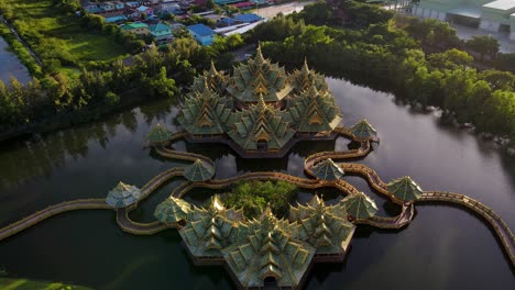 epic fly in of a breath taking temple on a lake at dawn ancient city siam, bangkok, thailand