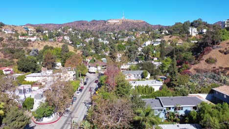 aerial above beachwood drive in hollywood with cars driving up towards hollywood sign 2