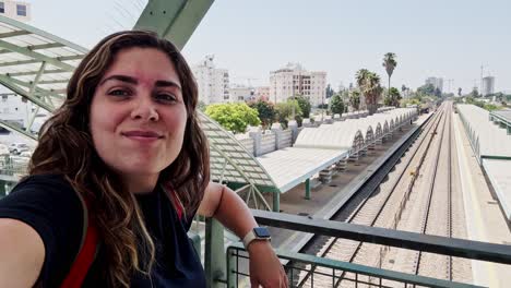 woman starting a journey at a city train station