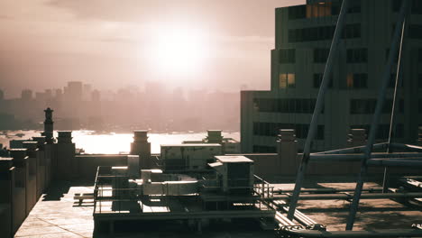 sunset over the city skyline viewed from a rooftop terrace during golden hour