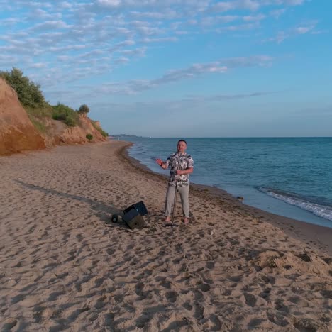 man having fun on the beach. young man singing in microphone at beach outdoor event