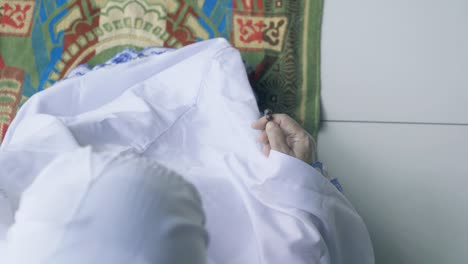 top view of old woman hold beads for dhikr