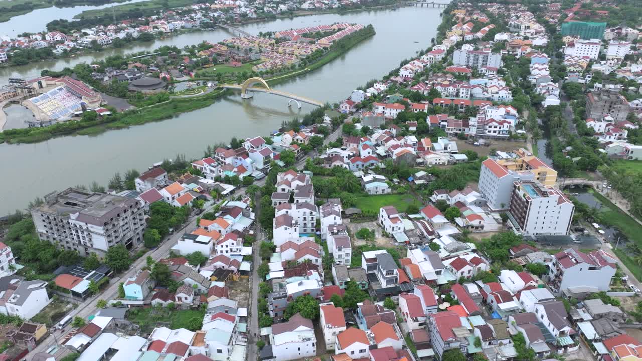 Colorful hoi an homes by the river on a peaceful sunny day, aerial view