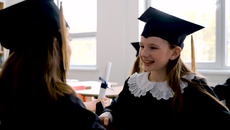 Two-Happy-Girls-Talking-In-Class