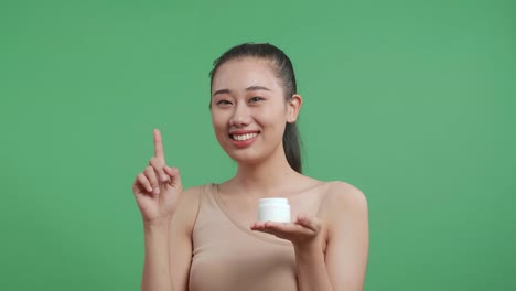 woman holding skincare cream jar