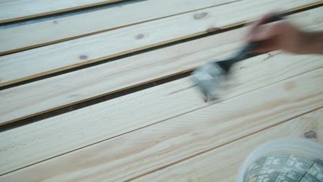 crop artisan varnishing wooden planks