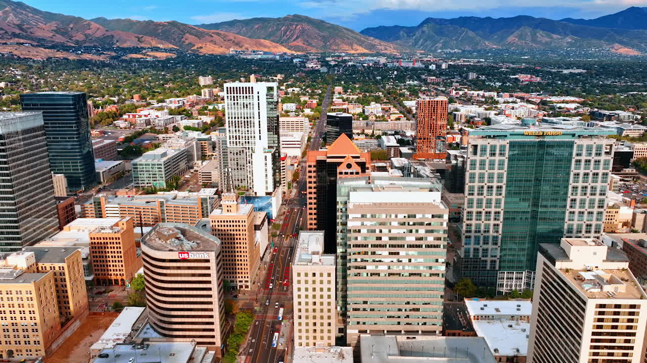 Salt Lake City, USA, 14 August 2025: Diversity of high-rises in the urban landscape of Salt Lake City, Utah, USA. Drone footage over the city revealing view on the green outskirts and bare mountains