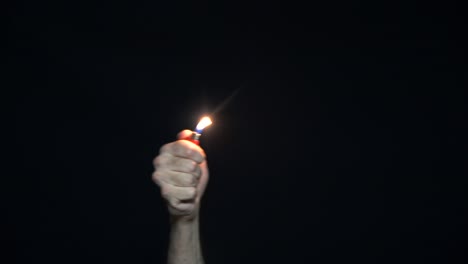 hand holding a lighter with a flame