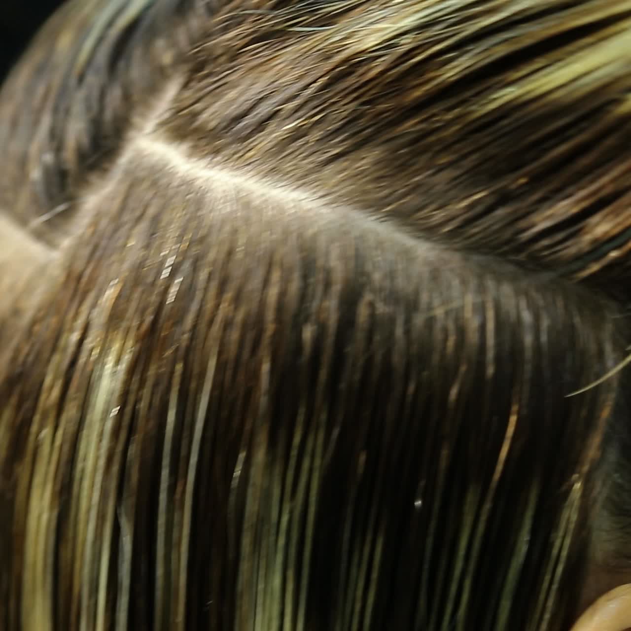 Professional stylist working with client