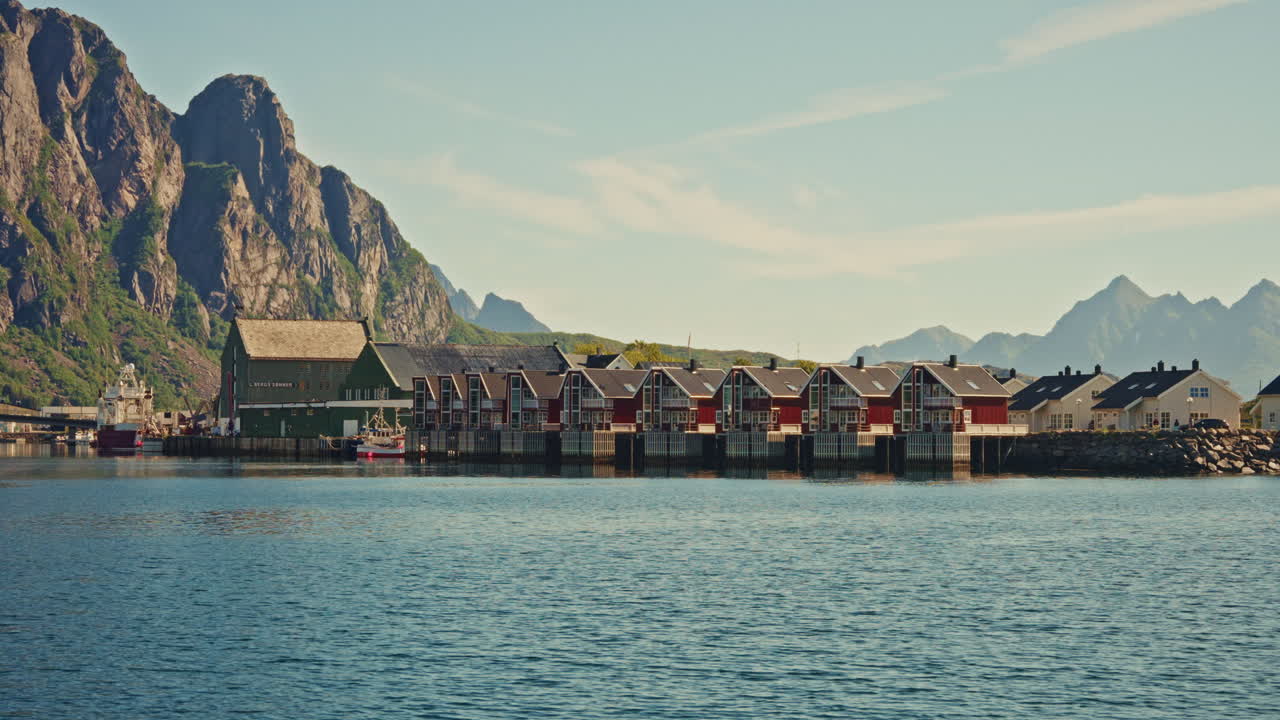 Boat tour around the Norwegian fjords in the Lofoten islands, Norway. View of the fishermen's cabins and the majestic landscape.