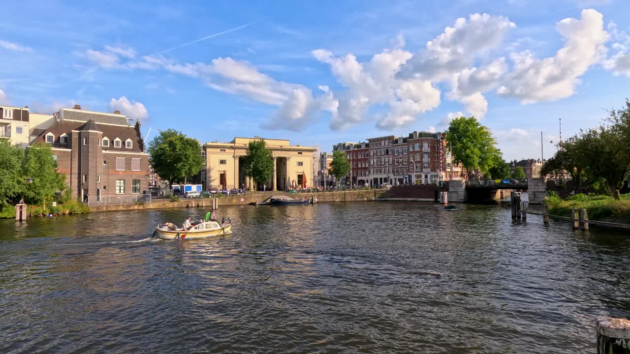 Motorboat glides along scenic Haarlem canal, historic architecture, sunny summer day, wide shot