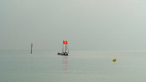 View-of-the-sea-from-Barcelona-beach-with-sailboats-in-the-water