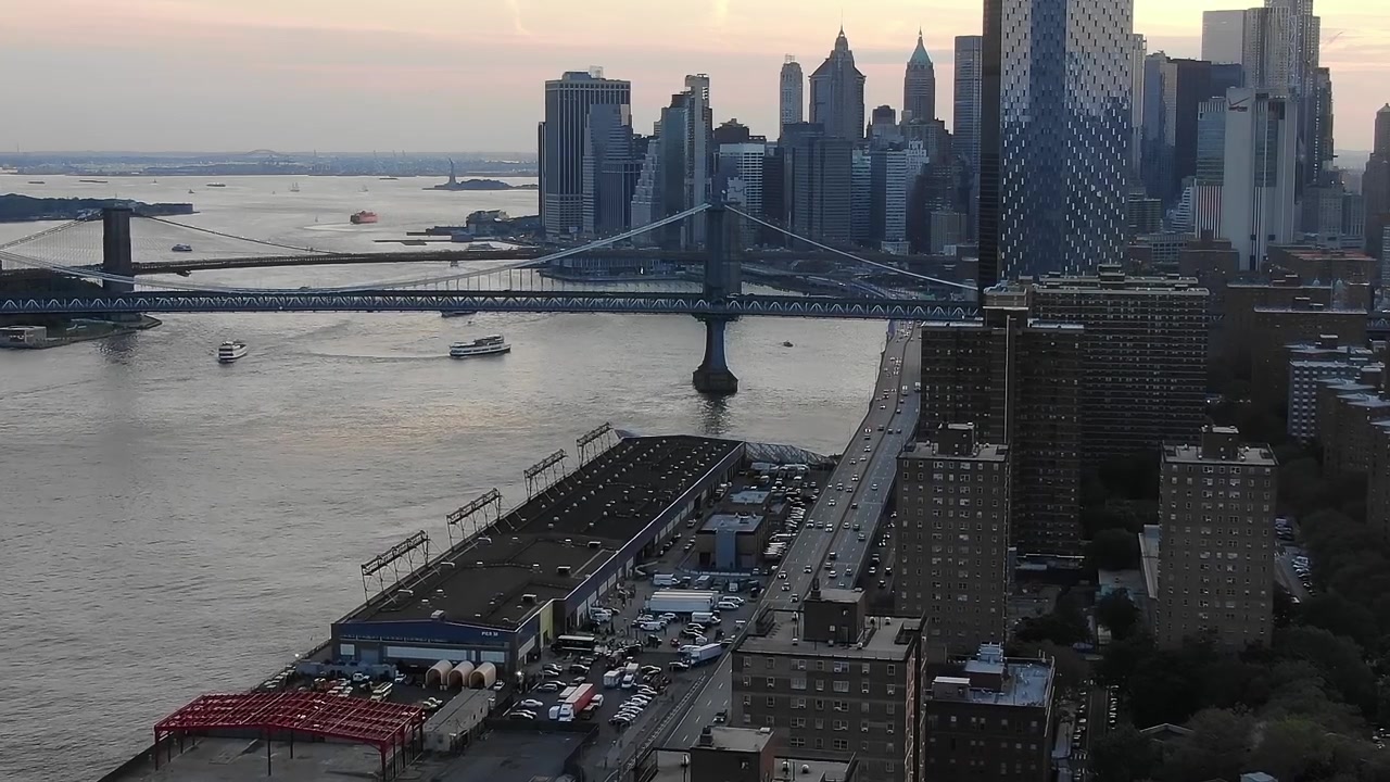 Utsikt over Manhattans skyline og Brooklyn Bridge i New York under solnedgang