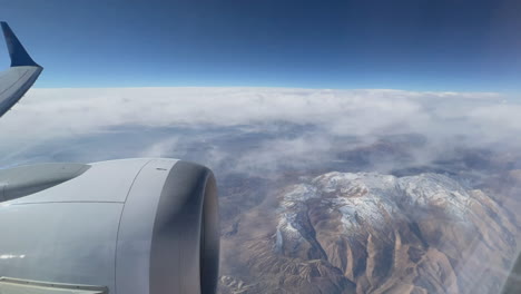 airplane view of mountains and clouds