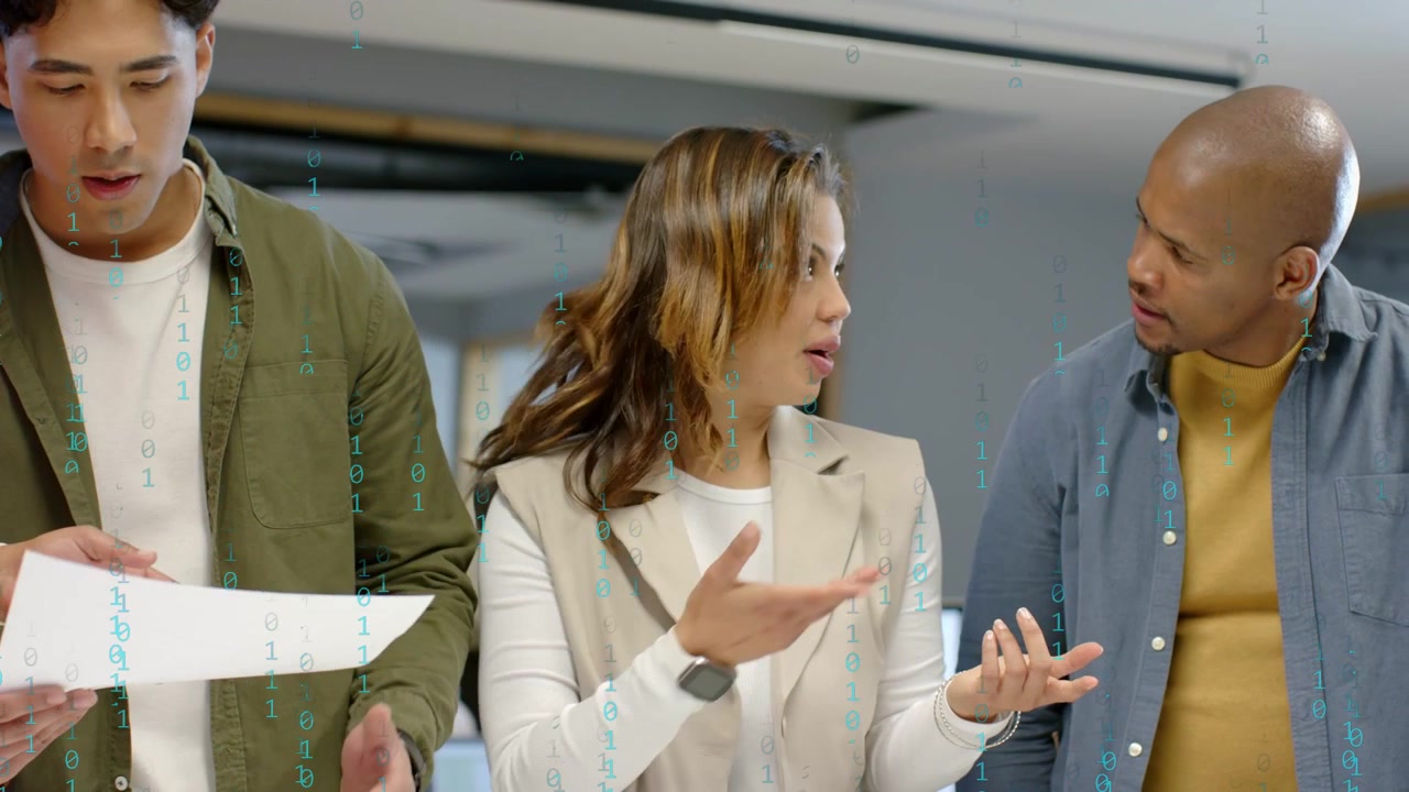 Left man holding sheet in office, lead woman pointing explaining lines, binary overlaying data