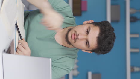 Vertical-video-of-Male-student-experiencing-Motivation-Loss.