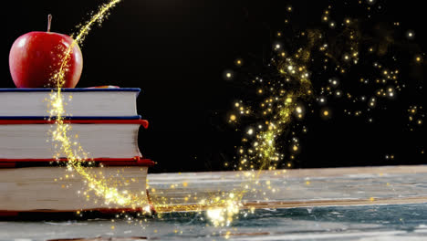 animation of glowing shooting star over apple on stack of books