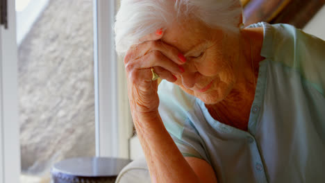 senior woman sitting sad at home 4k