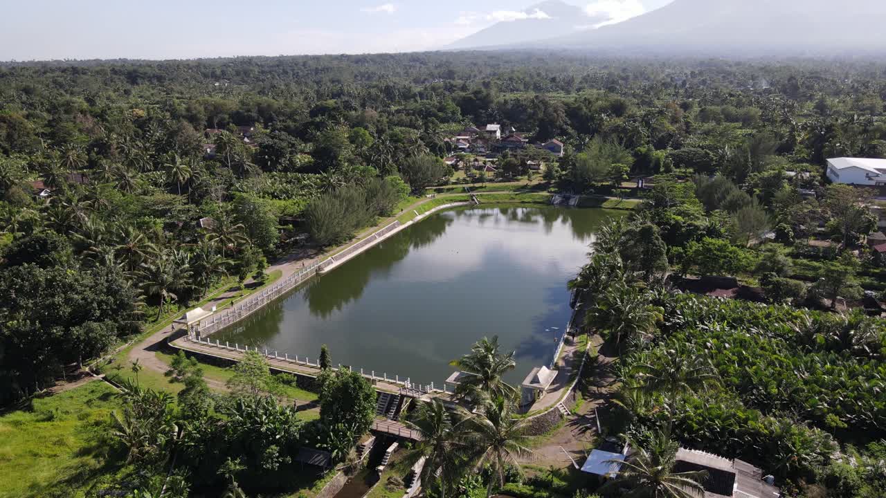 Beautiful aerial view of Kaliaji reservoir, a reservoir located in Turi, Sleman Regency, Yogyakarta. An attractive reservoir with a view of Mount Merapi in the background.