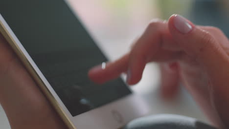 female hand typing on tablet