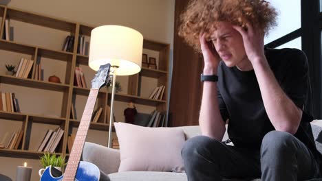 a young man with a strange hairstyle is talking on the phone a young man with a strange hairstyle is talking on the phone happy curly redhaired young man talking on the phone technologies and communications