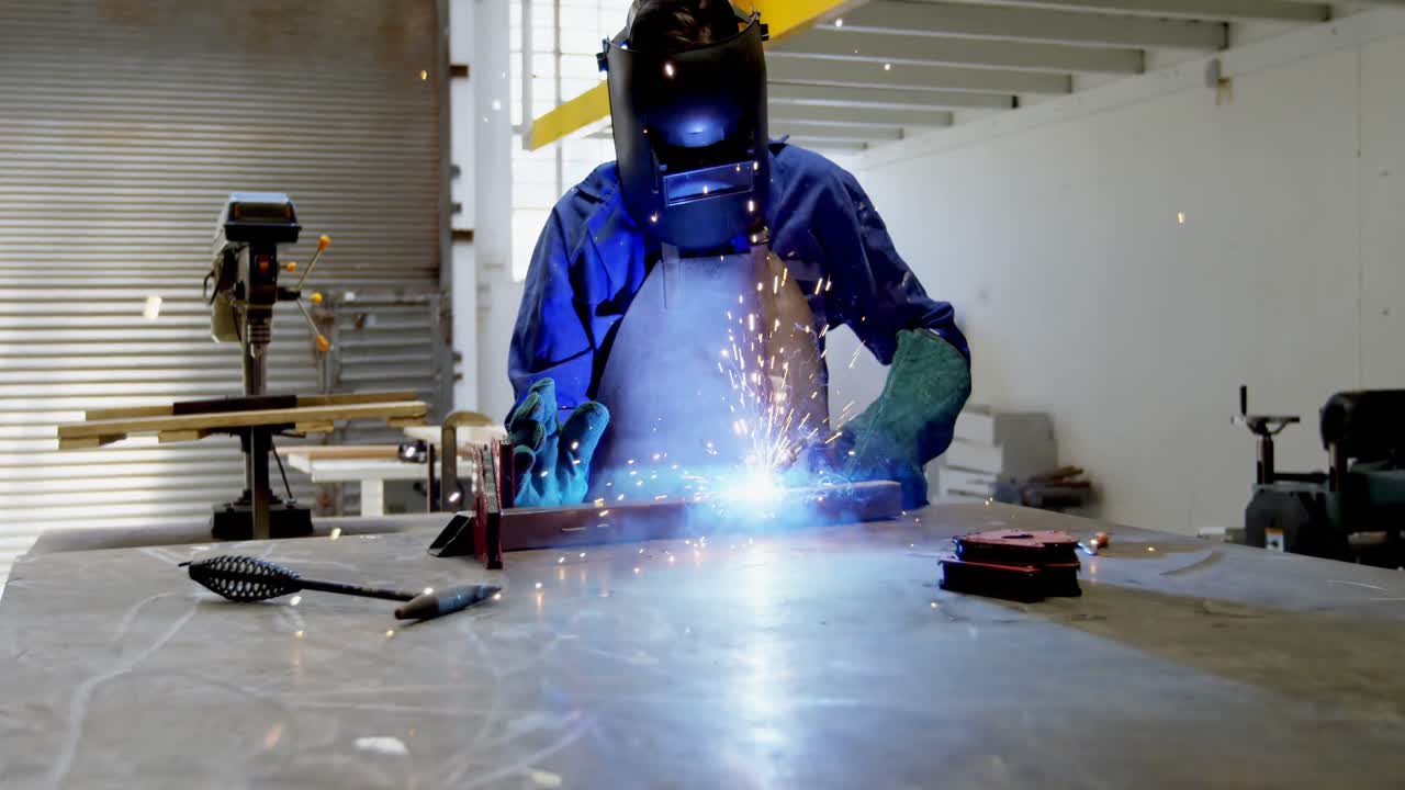 Female welder using blow torch on a rod 4k